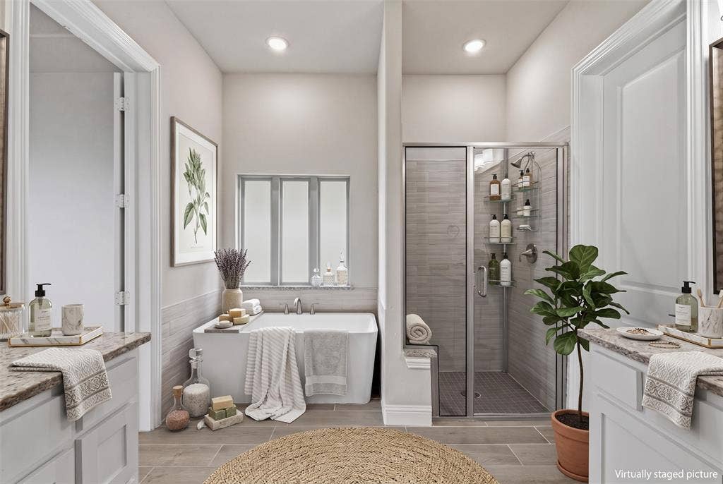 Dual vanities with granite countertops, a built-in bathtub, a walk-in shower with glass enclosure, and tiled flooring