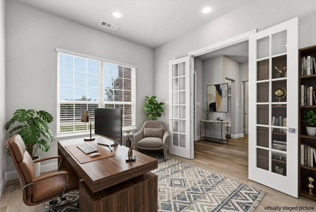 Wood-finish flooring, recessed lighting, and a large window with blinds