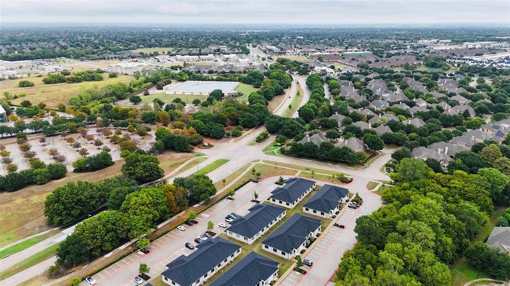 3721 S Stonebridge Drive, #704, McKinney, TX 75070 Expansive residential area featuring numerous single-family homes, mature trees, and a network of paved roads