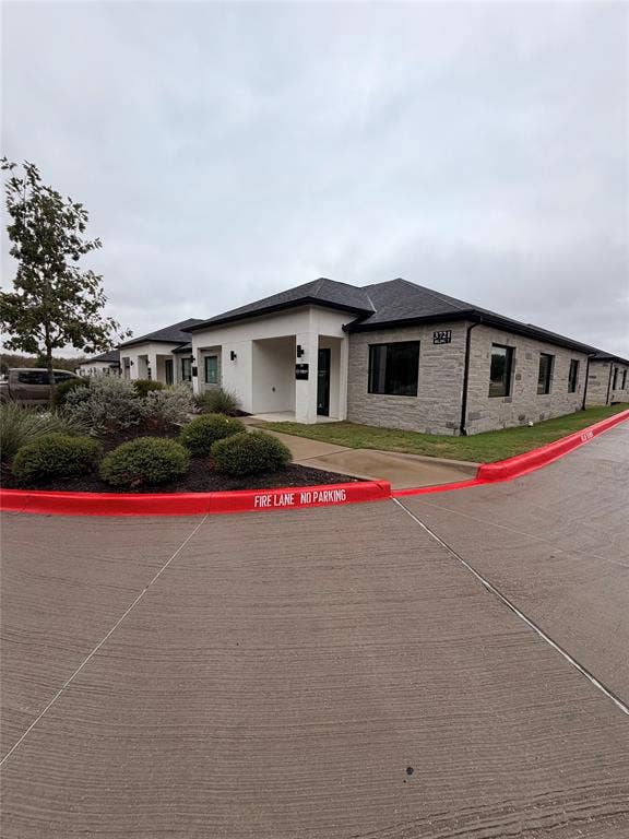 3721 S Stonebridge Drive, #704, McKinney, TX 75070 Modern facade featuring stone and stucco finishes