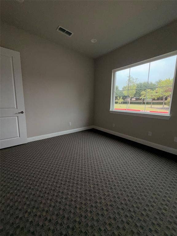 3721 S Stonebridge Drive, #704, McKinney, TX 75070 Neutral tone wall paint, patterned carpet flooring, recessed ceiling lighting, and a window with white trim