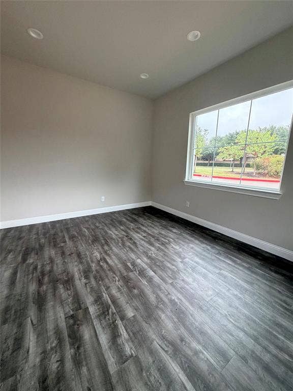 3721 S Stonebridge Drive, #704, McKinney, TX 75070 Wood-finish flooring, recessed lighting, and a large window with white trim