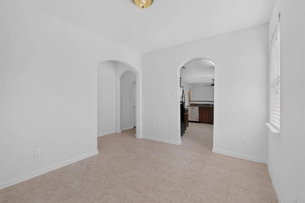 215 Magnolia Drive, Princeton, TX 75407 Light-toned tile flooring throughout with arched doorways