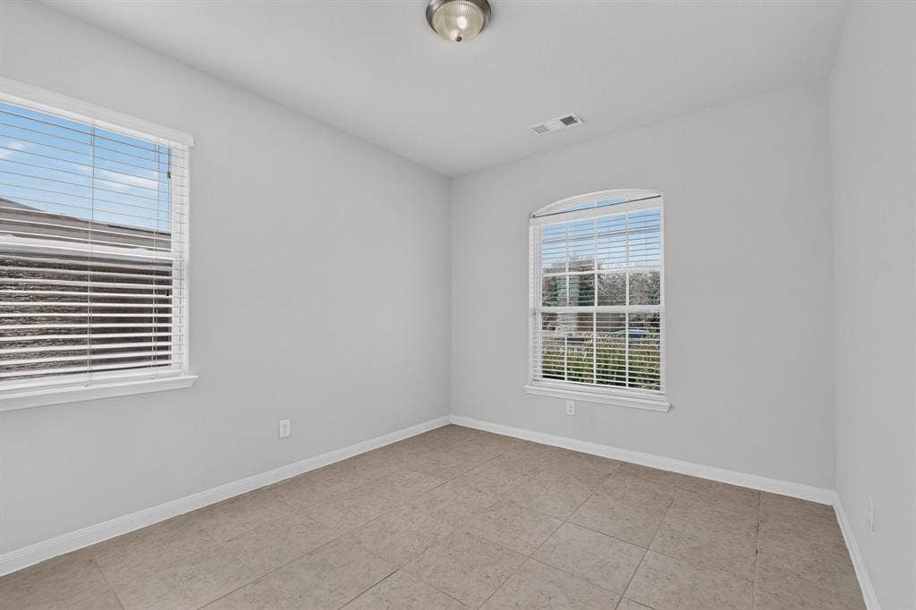215 Magnolia Drive, Princeton, TX 75407 Neutral-toned walls paired with a tile floor
