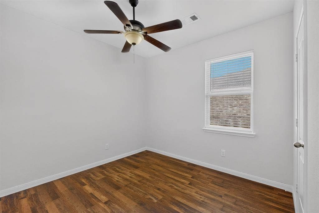 215 Magnolia Drive, Princeton, TX 75407 Wood-finish flooring, ceiling fan with integrated lighting, white trim, and a white interior door