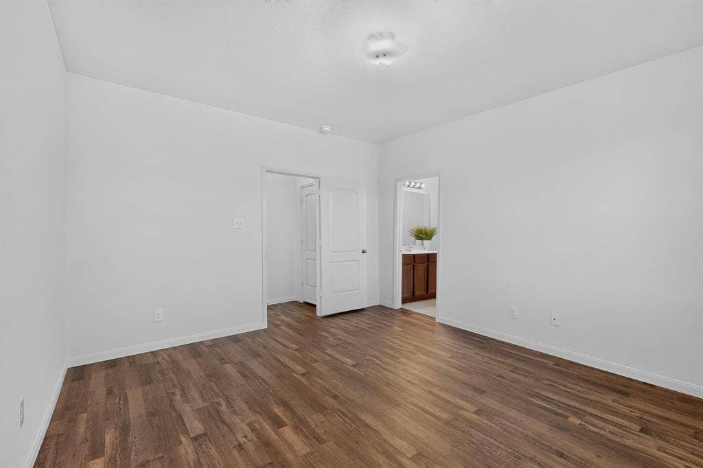 215 Magnolia Drive, Princeton, TX 75407 Wood-finish flooring, white walls, and a ceiling-mounted light fixture