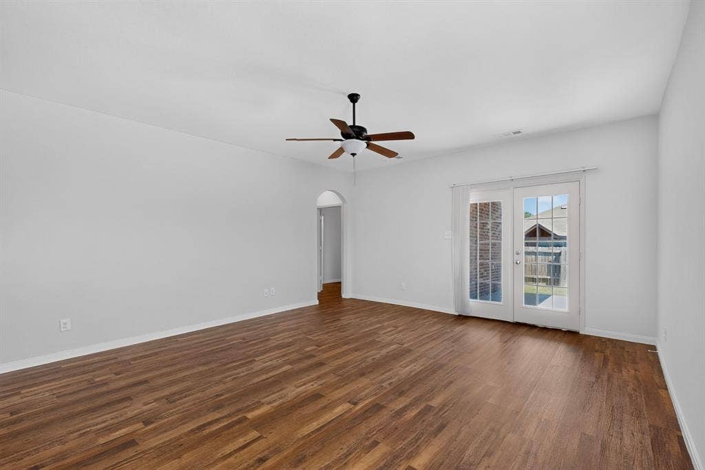 215 Magnolia Drive, Princeton, TX 75407 Spacious room with wood-finish flooring, ceiling fan, and white walls
