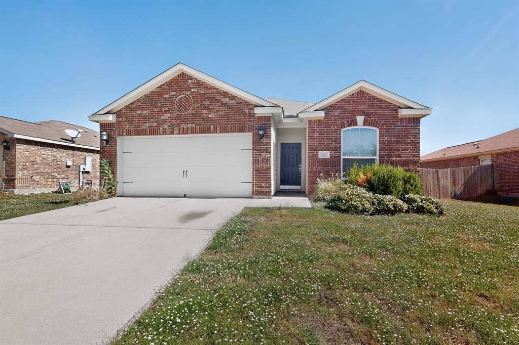 215 Magnolia Drive, Princeton, TX 75407 Brick exterior with a gabled roofline, featuring an integrated single-car garage