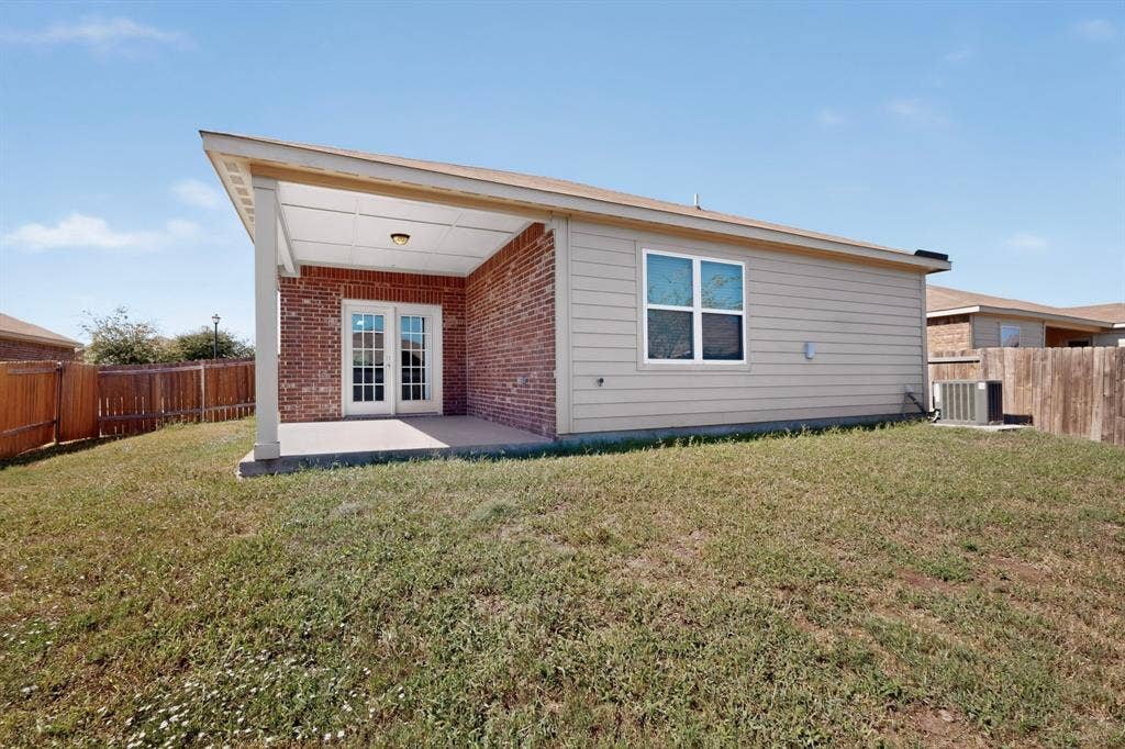 215 Magnolia Drive, Princeton, TX 75407 Covered patio with a concrete slab, French doors, and brick siding