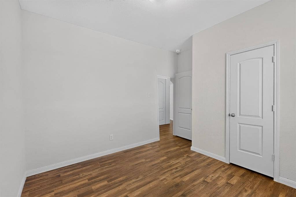 215 Magnolia Drive, Princeton, TX 75407 Neutral wall color with wood-finish flooring