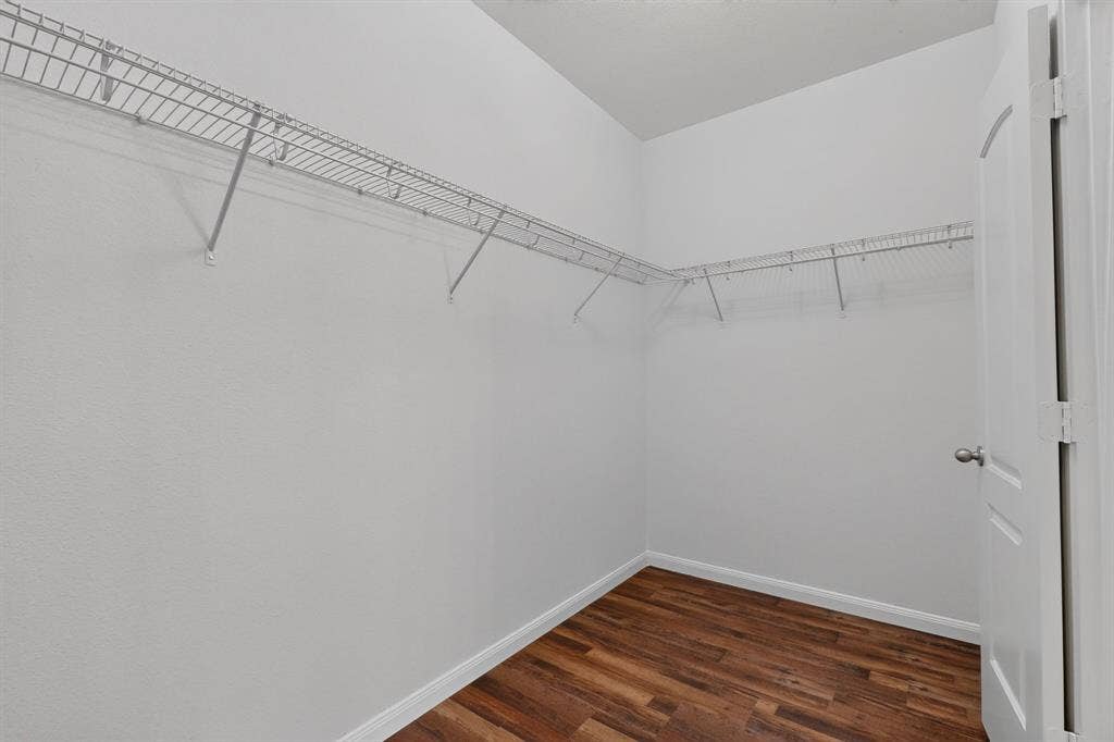 215 Magnolia Drive, Princeton, TX 75407 Spacious closet featuring wire shelving, wood-finish flooring, and a white paneled door