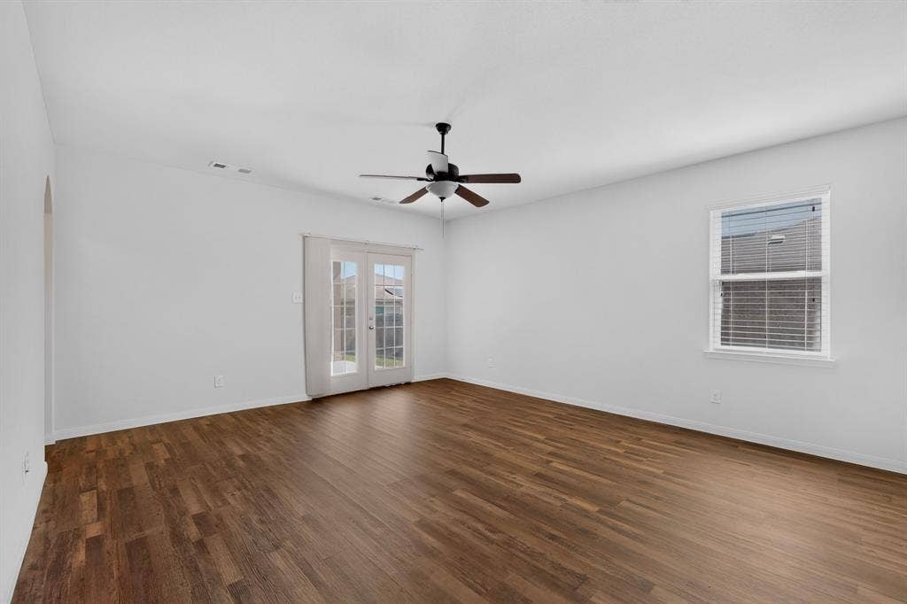 215 Magnolia Drive, Princeton, TX 75407 Wood-finish flooring, white walls, and a ceiling fan with light fixture