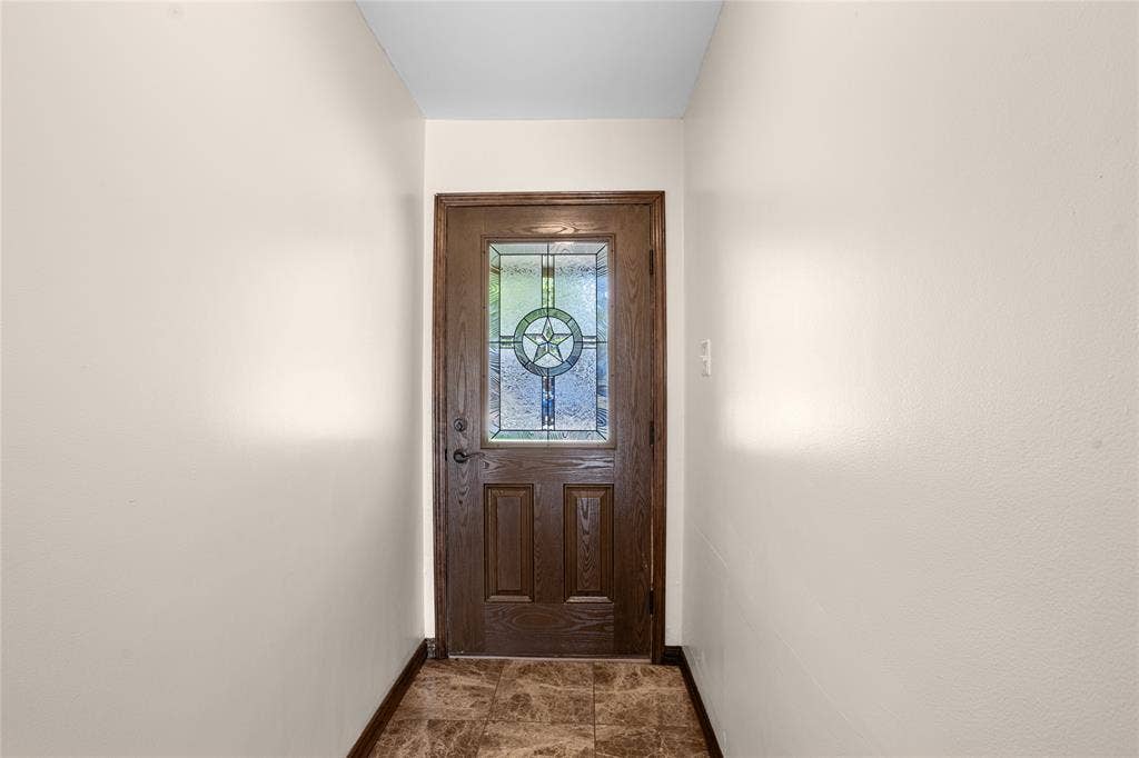 2004 Ford Street, Arlington, TX 76013 Wood-finish entry door with decorative glass inlay, durable tile flooring, and neutral wall finishes