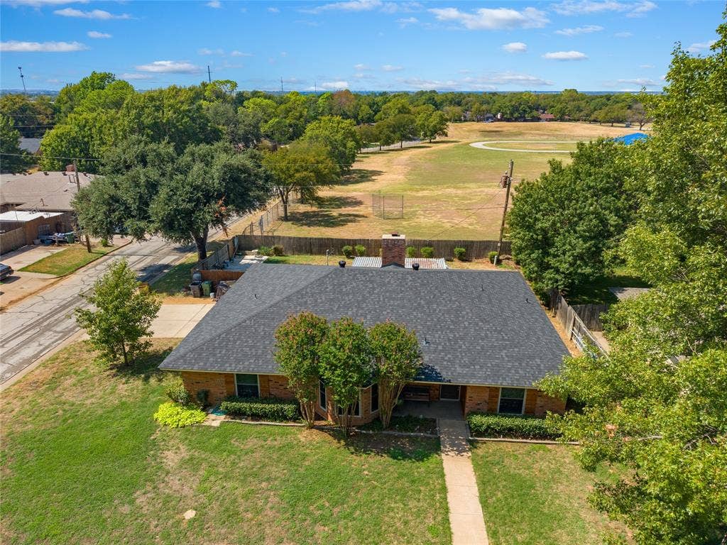 2004 Ford Street, Arlington, TX 76013 Brick exterior with a dark shingle roof and a concrete walkway