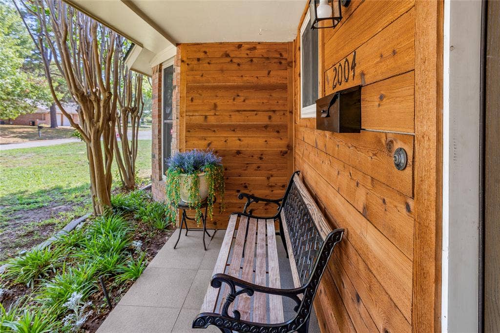 2004 Ford Street, Arlington, TX 76013 Wood-paneled exterior wall with integrated mailbox and house numbers