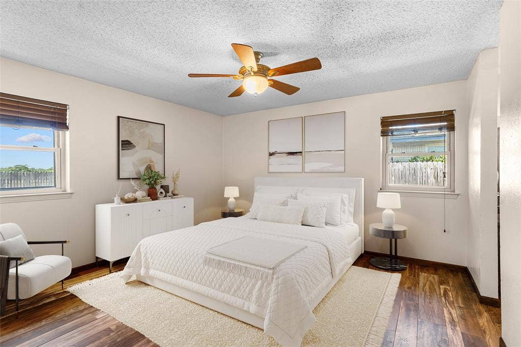 2004 Ford Street, Arlington, TX 76013 Virtually Staged Bedroom with Wood-finish flooring, ceiling fan with integrated lighting, and two windows with blinds