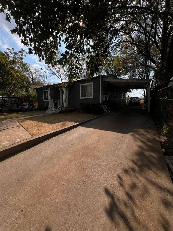3515 Clinton Avenue, Fort Worth, TX 76106 Grey siding exterior with white trim windows and a covered carport