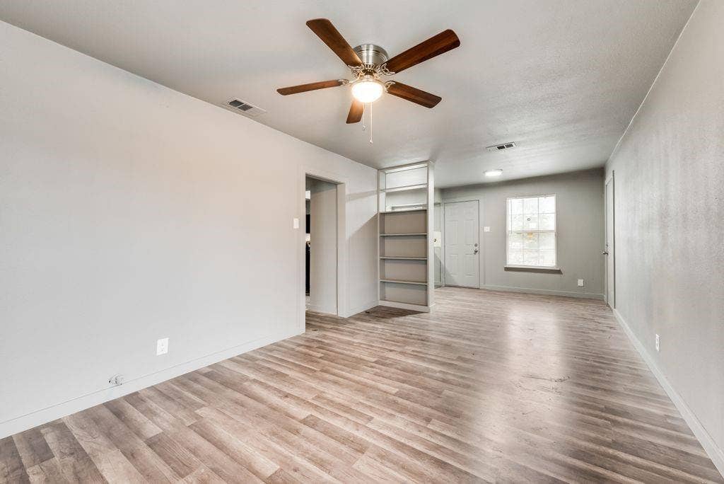 4414 Cinda Ree Lane, Dallas, TX 75216 Spacious interior with wood-finish flooring, a ceiling fan, and built-in shelving