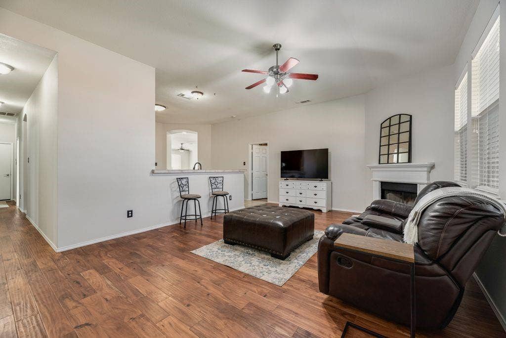 1323 Canyon Creek Road, Wylie, TX 75098 Wood-finish flooring, vaulted ceilings, and a ceiling fan