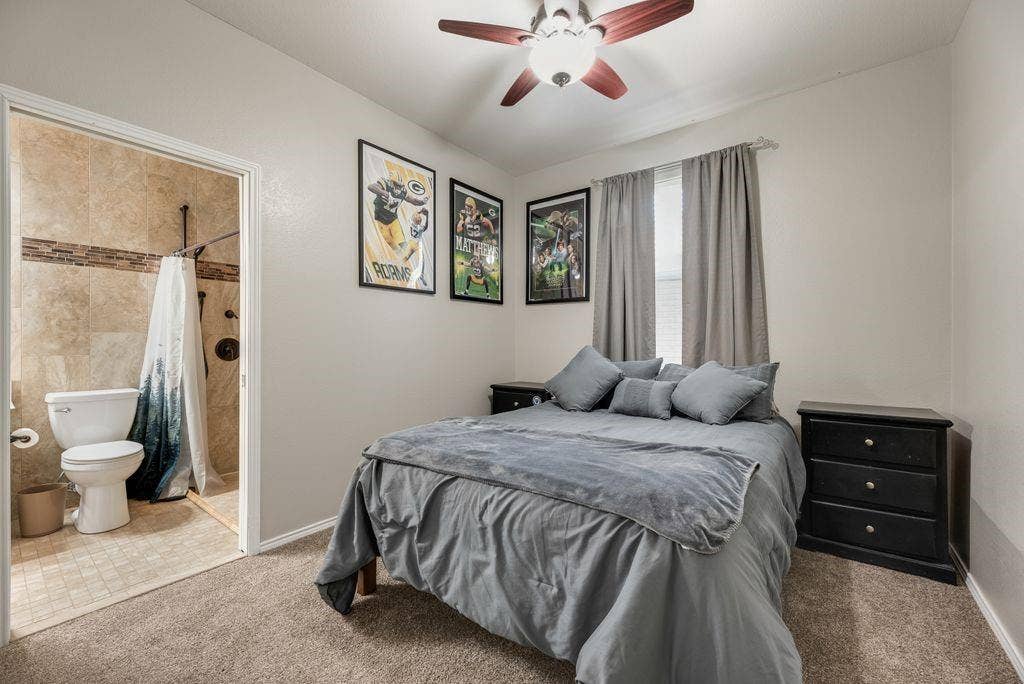 1323 Canyon Creek Road, Wylie, TX 75098 Recessed lighting, ceiling fan, wall-to-wall carpeting, and an attached three-piece bathroom with tiled walls and flooring