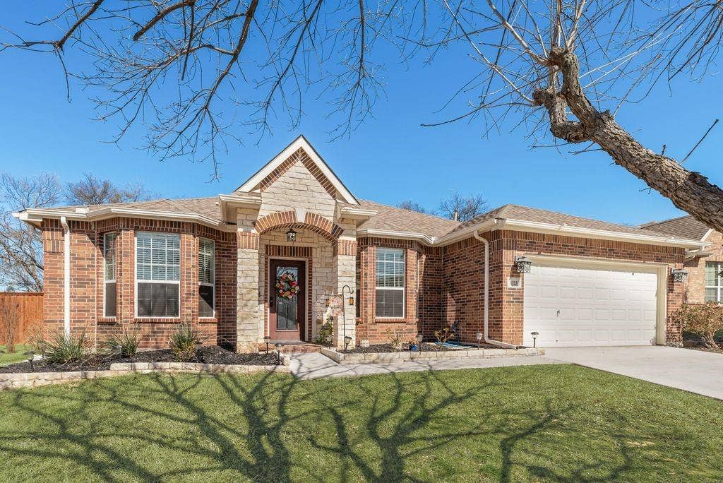 1323 Canyon Creek Road, Wylie, TX 75098 Brick exterior with stone accents and a covered entryway