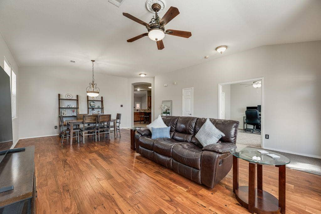 1323 Canyon Creek Road, Wylie, TX 75098 Open-concept living space featuring wood-finish flooring, a decorative ceiling fan, and recessed lighting
