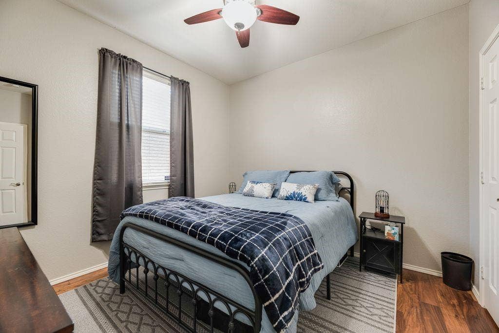 1323 Canyon Creek Road, Wylie, TX 75098 Room featuring wood-finish flooring, a ceiling fan, and a single window with blinds and drapes