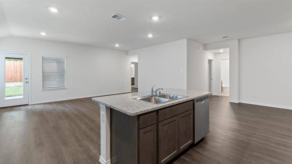 5012 Shumard Drive, Lindale, TX 75771 Kitchen island with a double stainless steel sink and integrated dishwasher