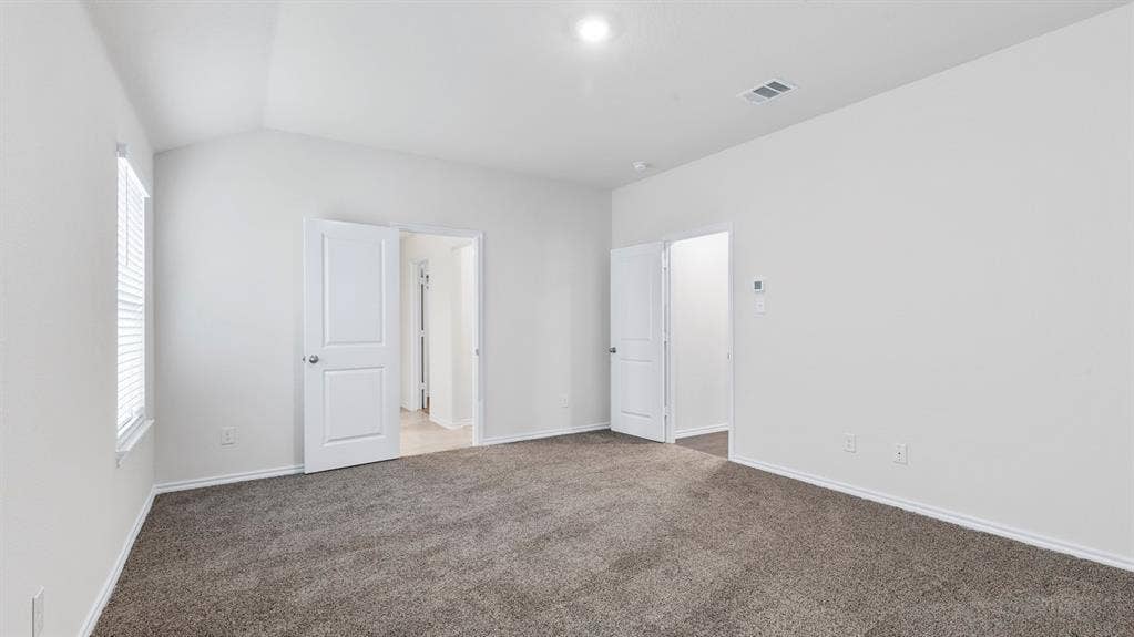 5012 Shumard Drive, Lindale, TX 75771 Vaulted ceiling with recessed lighting, neutral tone carpeting, and a window with blinds
