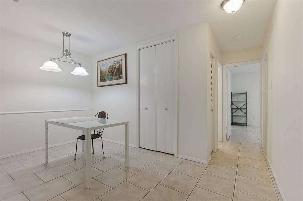 5981 Arapaho Road, #103, Dallas, TX 75248 Tiled flooring extends throughout the space and into the hallway