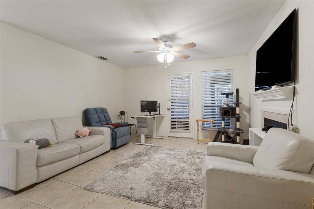 5981 Arapaho Road, #103, Dallas, TX 75248 Recessed lighting, tile flooring, ceiling fan, and a built-in fireplace