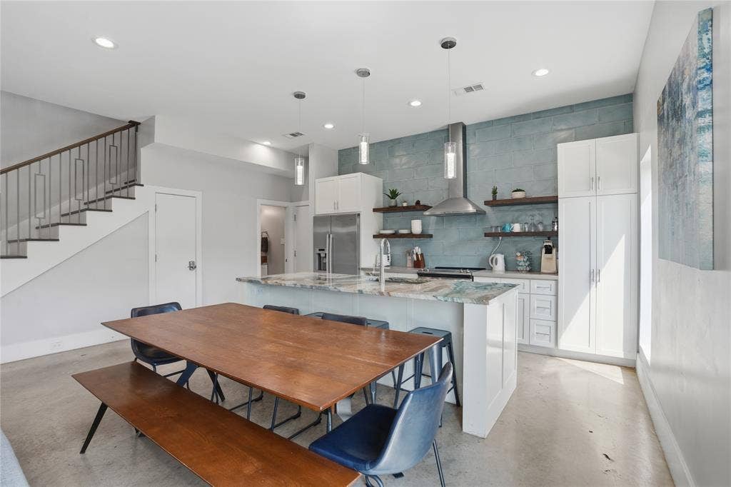 180 S Cisco Street, Dallas, TX 75246 Kitchen features floating shelves, custom countertops and backsplash, and S/S appliances