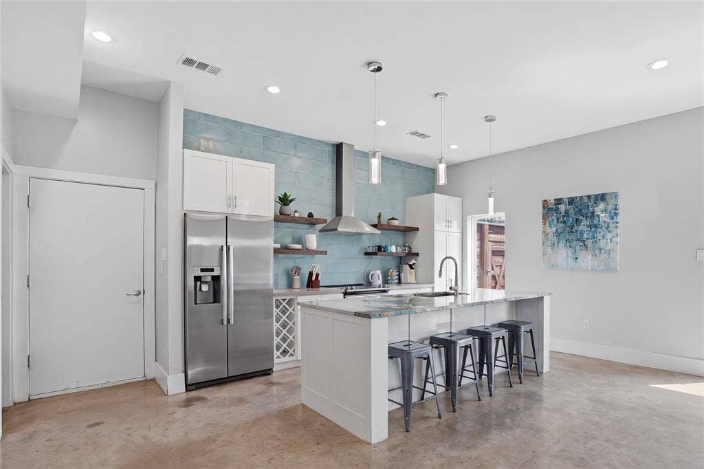 180 S Cisco Street, Dallas, TX 75246 Welcome to 180 S Cisco! Featuring a knocked out kitchen, concrete flooring, and incredible custom stonework throughout