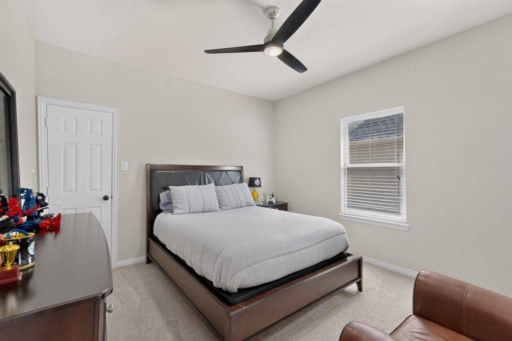 1494 Willingham Drive, Allen, TX 75013 Vaulted ceiling with a contemporary ceiling fan, window with blinds, paneled interior door, and carpet flooring