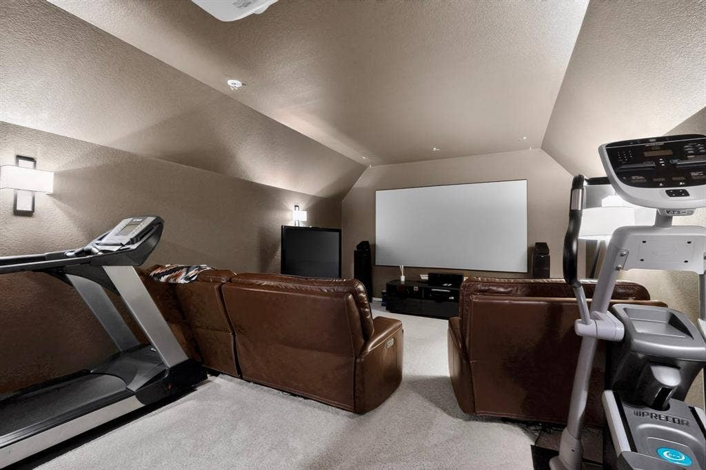 1494 Willingham Drive, Allen, TX 75013 Spacious room featuring sloped ceilings, recessed lighting, and wall sconces