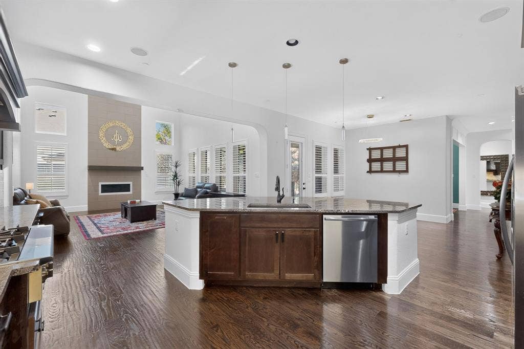 13853 Myatt Avenue, Frisco, TX 75035 Open-concept living space with dark wood-finish flooring