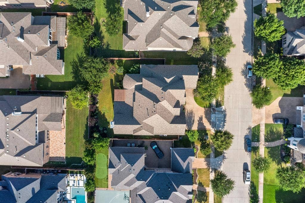 13853 Myatt Avenue, Frisco, TX 75035 Aerial perspective showcasing a residential property with a multi-gabled roof and a paved driveway