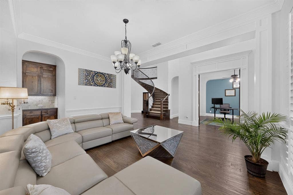 13853 Myatt Avenue, Frisco, TX 75035 Spacious interior featuring dark wood-finish flooring and a decorative chandelier