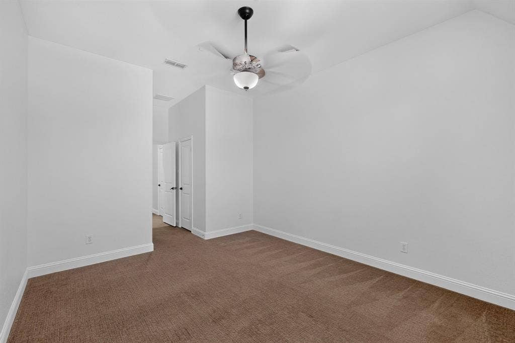 13853 Myatt Avenue, Frisco, TX 75035 Spacious room featuring neutral carpeting, white walls, and a ceiling fan with integrated lighting