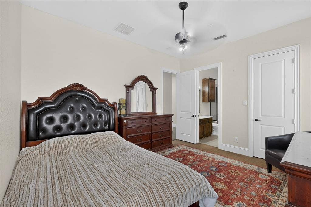 13853 Myatt Avenue, Frisco, TX 75035 Carpeted bedroom featuring neutral-toned walls, a ceiling fan with integrated lighting, and a white paneled door