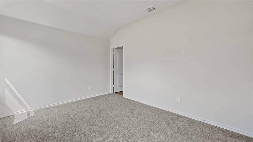 1667 Blaire Drive, Tyler, TX 75702 Neutral paint palette with vaulted ceilings and light gray carpet