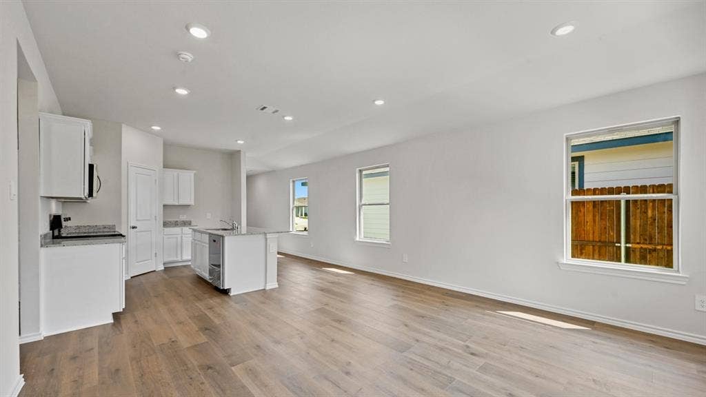 1667 Blaire Drive, Tyler, TX 75702 Open-concept living area featuring wood-finish flooring, recessed lighting, and multiple windows
