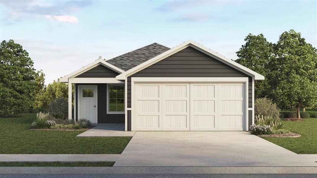 1667 Blaire Drive, Tyler, TX 75702 Dark siding exterior with white trim, a two-car garage, and a concrete driveway