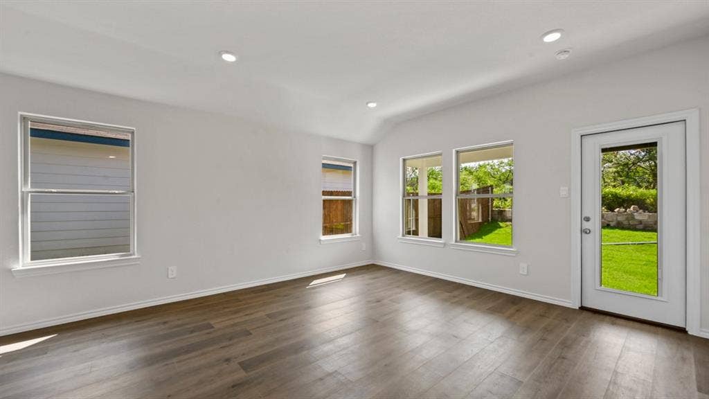1667 Blaire Drive, Tyler, TX 75702 Spacious room featuring wood-finish flooring, recessed lighting, and multiple windows