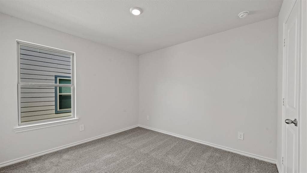 1667 Blaire Drive, Tyler, TX 75702 Neutral wall paint with coordinating trim, carpeted flooring, and a single window