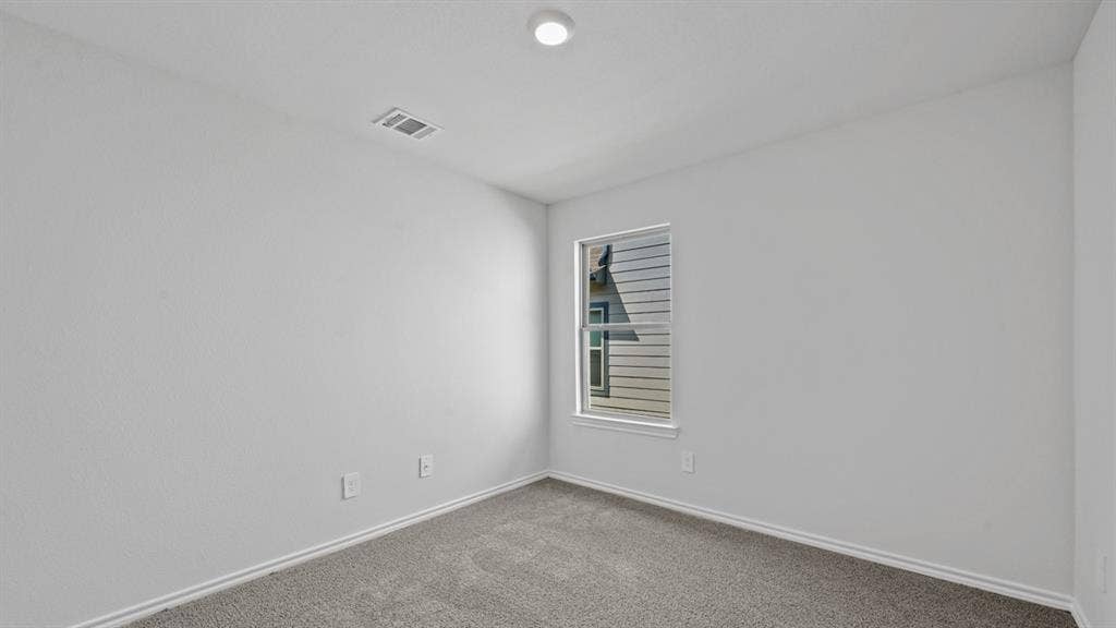 1667 Blaire Drive, Tyler, TX 75702 Neutral white walls with a single window and recessed ceiling lighting