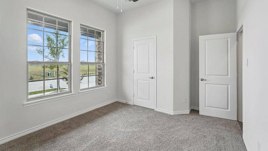 2510 Wesley Avenue, Royse City, TX 75189 Room featuring two large windows with grid muntins, light gray carpeting, and white baseboards