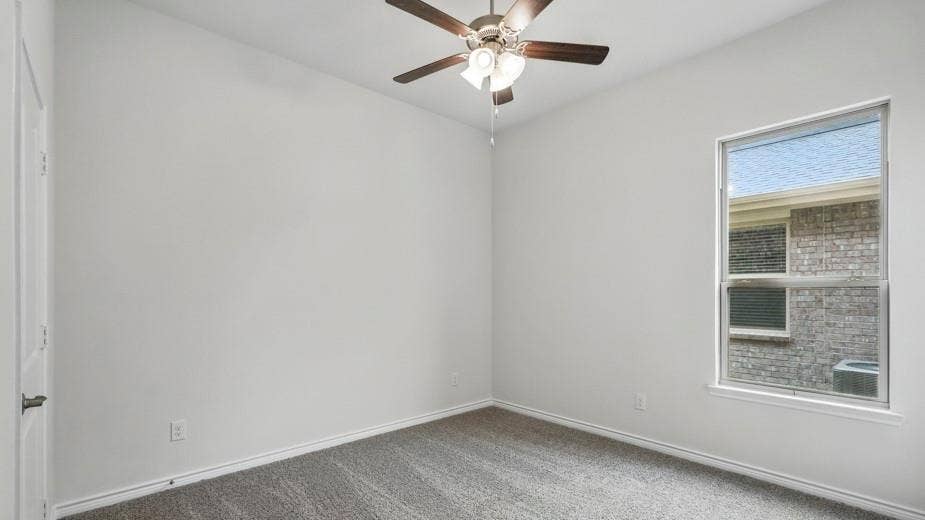 2510 Wesley Avenue, Royse City, TX 75189 Interior room featuring light-colored walls, grey carpeting, a ceiling fan with integrated lighting, and a white-framed window