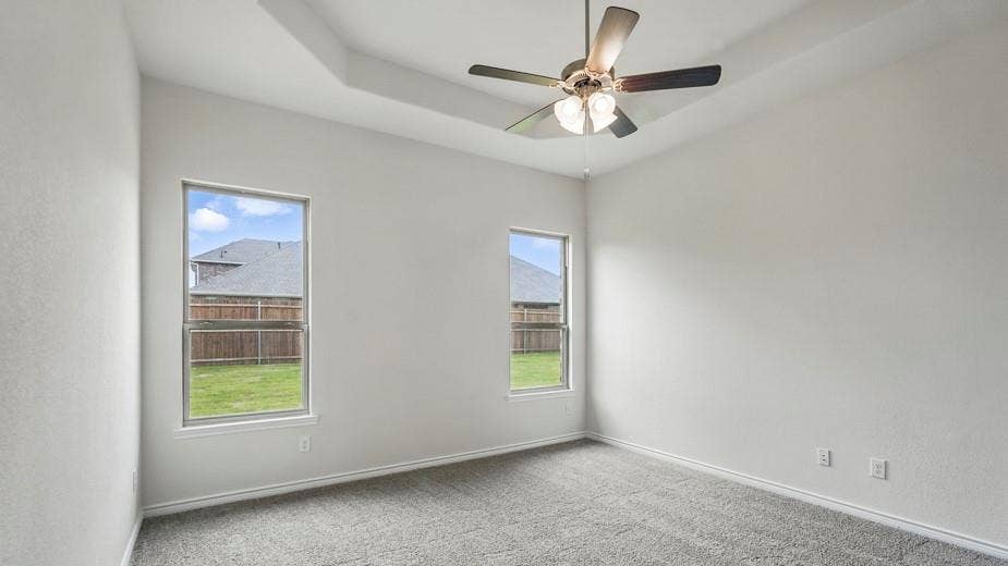 2510 Wesley Avenue, Royse City, TX 75189 Spacious room featuring a tray ceiling, ceiling fan with integrated lighting, and neutral wall paint