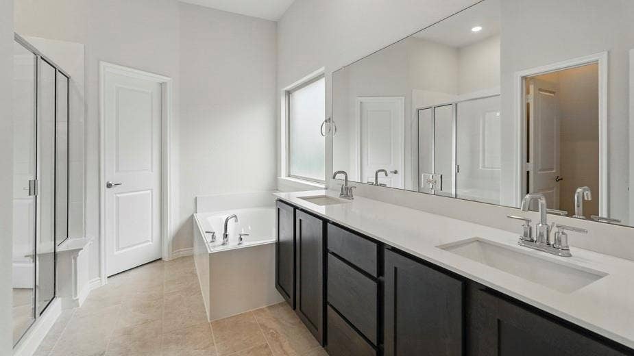 2510 Wesley Avenue, Royse City, TX 75189 Contemporary bathroom featuring a spacious dual vanity with dark wood-finish cabinetry and light-toned countertops